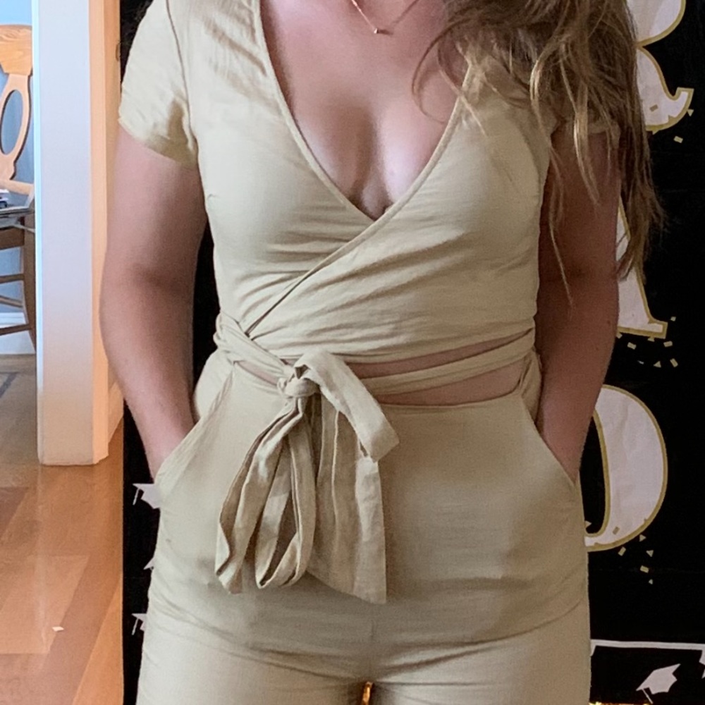 Size small beige colored jumpsuit that ties in the front